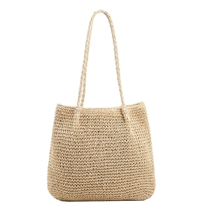 Large beige woven straw tote bag with thin shoulder straps for beach summer vacation