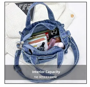 Top view showing large interior capacity of denim crossbody bag with daily essentials