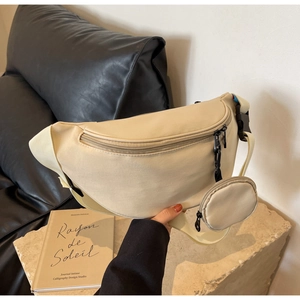 Detail of cream canvas crossbody bag with a detachable small round coin purse accessory