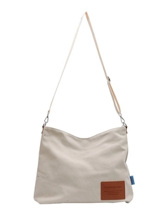 Minimalist off-white canvas crossbody bag with leather patch and adjustable strap