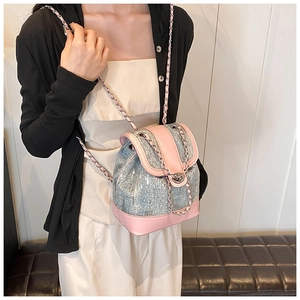 Mini paillette bucket backpack with light blue sequins and pink leather trim on model