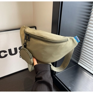 Army green nylon chest bag with zip closure and matching round coin purse held in hand