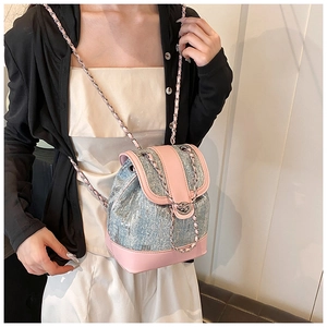Close-up of sequins on sequined bucket backpack with pink leather trim and chain