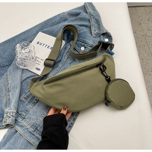 Detail of olive green nylon chest bag with adjustable strap and small round coin purse