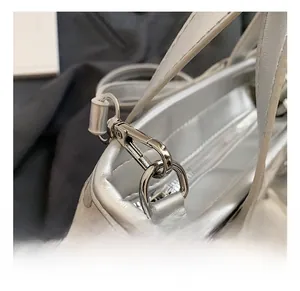Detailed macro view of high-quality silver metallic hook and glitter fabric texture on bag