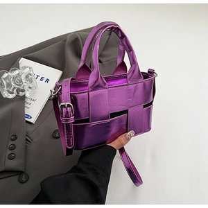 Close-up of metallic purple woven bucket bag with detailed braided texture and top handles