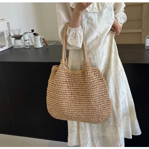Close-up of a woven straw tote bag featuring a bohemian style and large capacity design