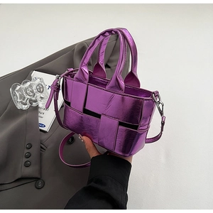 Close-up of metallic purple woven bucket bag with polished texture and top handle