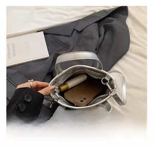 Detailed interior of a silver mini tote bag showing space for phone and essentials