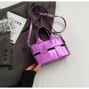 Close-up of metallic purple woven bucket bag featuring glossy wide-strip texture