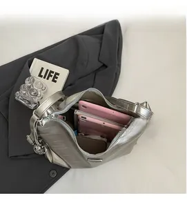 Interior view of large silver tote bag showing spacious storage for tablets and wallets
