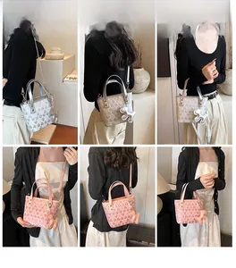 Model display of heart-embossed tote bag in silver and pink with puppy charm