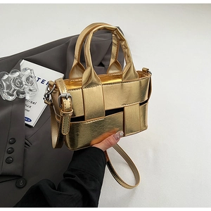Detail of gold woven mini bucket bag with metallic leather texture and silver buckle
