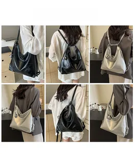 Detailed views of high-gloss embossed tote bag in silver and black with metal charms