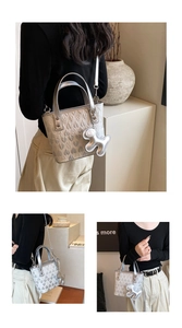 Close-up of silver heart-embossed tote bag with metallic finish and cute charm detail