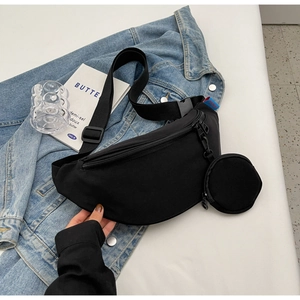 Detail of black nylon crescent moon crossbody bag with detachable round coin purse