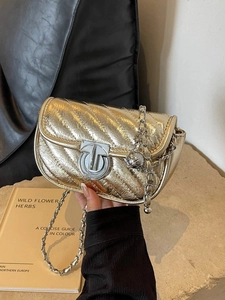 Quilted metallic gold chain crossbody bag with silver twist lock and decorative metal ball