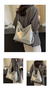 Detail of silver metallic tote showing the triangle logo and convertible strap design