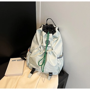 Detail of light green nylon backpack with drawstring closure and Tennis Boy Club embroidery