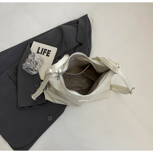 Detailed interior of cream tote bag showing spacious compartments and zip pocket