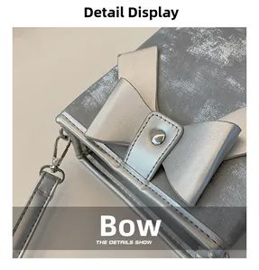 Detail showing the brushed silver texture and large metallic bow on this bucket bag