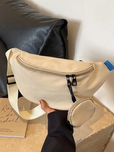 Minimalist beige canvas half-moon crossbody bag with adjustable strap and coin purse