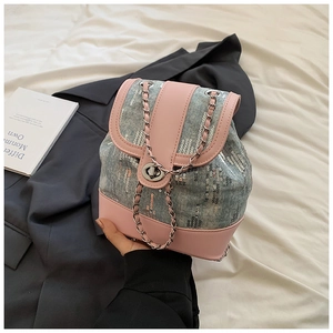 Detail of light blue denim mini backpack with pink leather and silver sequins