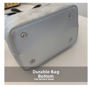 Detailed macro view of the silver metallic leather bag bottom with four metal base studs