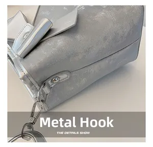 Detailed macro view of silver metallic textured bucket bag with high-quality metal hooks