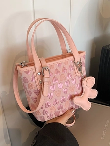 Pink heart-textured handbag with top handle and adjustable strap for women
