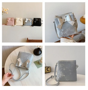 Detail view of mini bucket bag with large bow decoration and matte textured finish