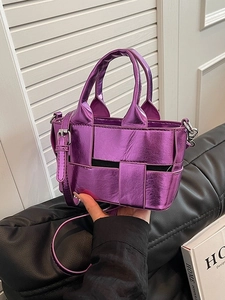 Purple metallic woven bucket bag with top handle and adjustable shoulder strap