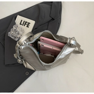 Top view of metallic silver tote bag showing large capacity with tablets and phone inside