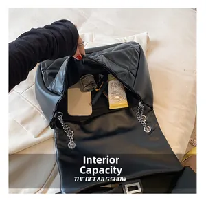 Interior view showing the large storage capacity of quilted leather shoulder bag with chain