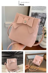 Detailed views of the pink bucket bag with bow detail and silver metal hardware