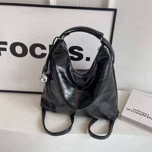 Glossy black embossed leather tote with silver metal ball charm and triangle plaque details