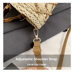 Detail show of adjustable leather strap and golden hardware on woven straw handbag