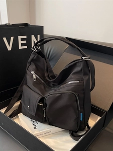 Versatile black nylon tote bag with multi-pocket design and adjustable shoulder straps