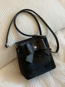 Fashionable black velvet bucket bag with large bow and adjustable shoulder strap for women