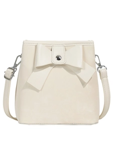 Creamy white bow bucket bag with silver metal buckle and adjustable shoulder strap