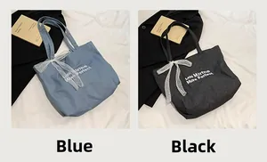 Blue and black denim tote bags featuring elegant lace bows and embroidered text details