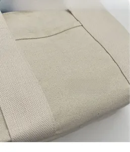 Close-up of durable canvas stitching and woven texture on this cream tote bag