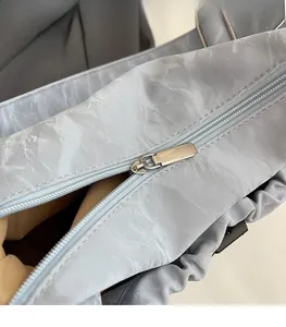 Macro detail of high-quality metal zipper and marble pattern texture on shoulder bag