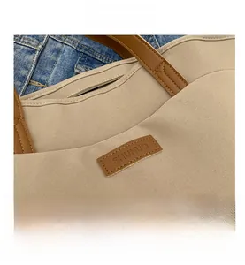 Detailed close-up of heavy-duty canvas tote bag with leather handles and premium stitching