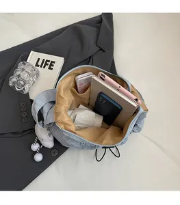 Macro shot of spacious inner compartment in grey crossbody bag with large storage capacity