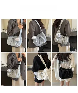 Detail view of stylish pleated crossbody bags in four colors with cute cloud pendants