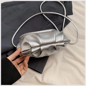 Detailed close-up of a silver pleated cloud bag featuring premium lychee pattern texture