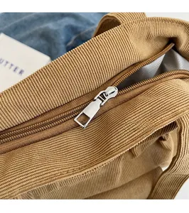 Detailed macro view of the smooth metal zipper and herringbone pattern fabric lining