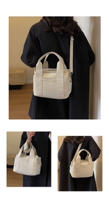 Detail view of cream canvas tote bag showing multiple pockets and adjustable shoulder strap