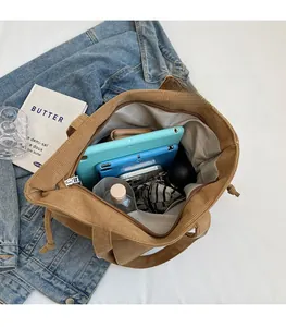 Top view of the brown corduroy tote bag interior showing large capacity and internal pockets